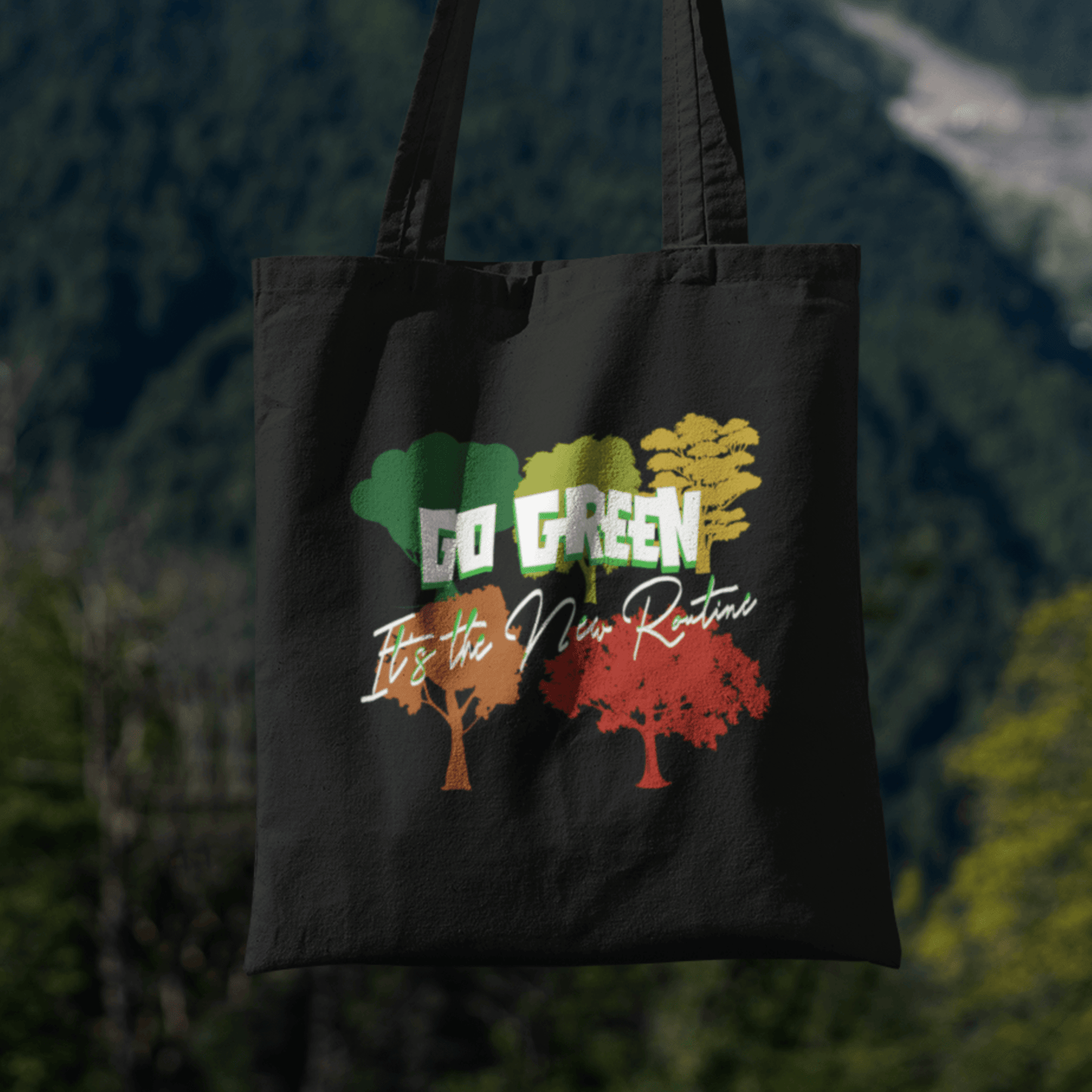 Eco tote bag with “Go Green It’s the New Routine” typography and colorful tree design printed on black organic cotton by LostLogicCo Canada.