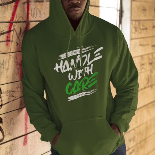 Model wearing green hoodie featuring bold “Handle with Care” brush text design, unisex motivational streetwear by LostLogicCo Canada