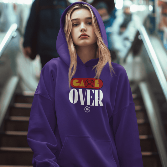 Model wearing purple hoodie with retro “Game Over” controller-themed graphic, unisex gamer streetwear by LostLogicCo Canada