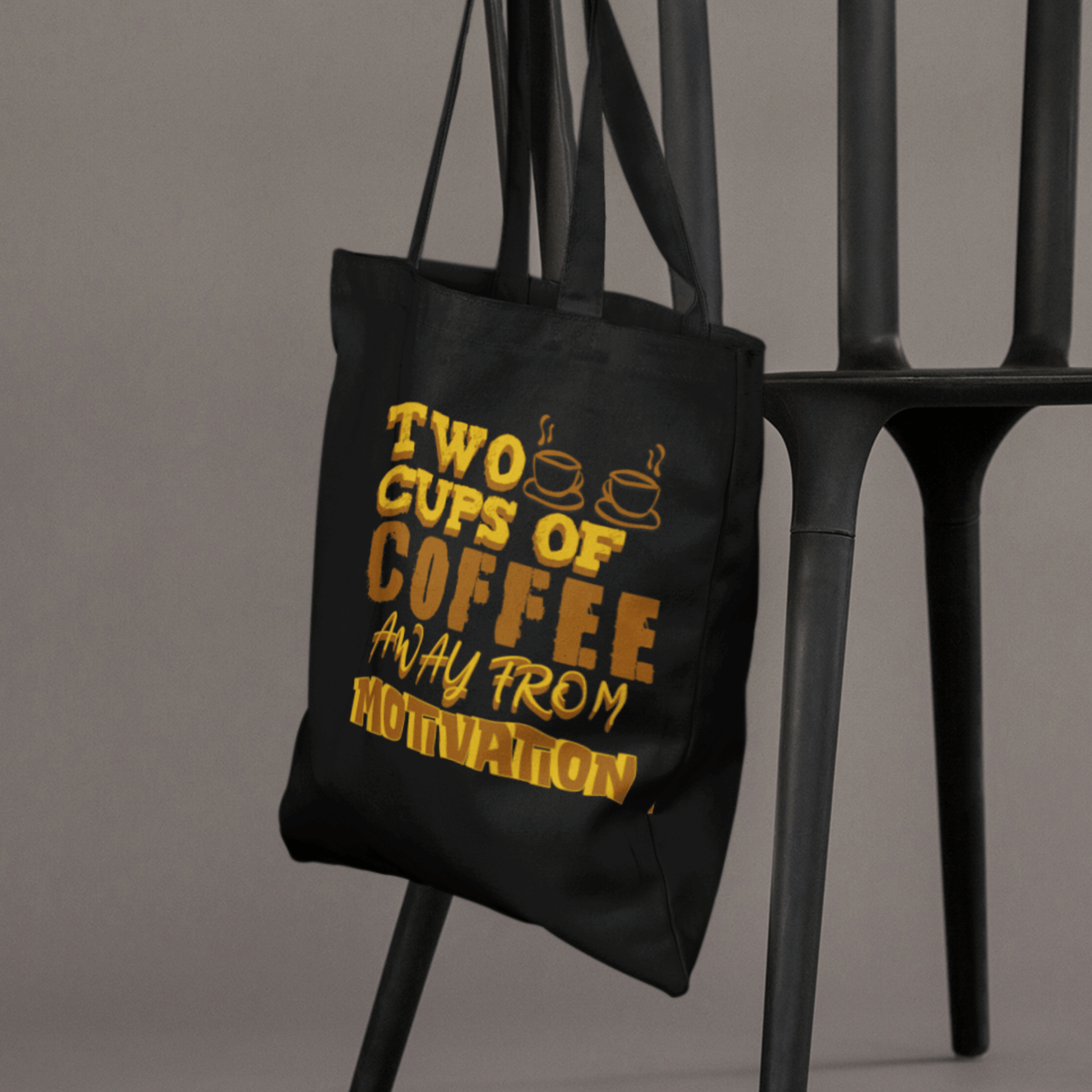Eco tote bag with “Two Cups of Coffee Away from Motivation” typography design in brown and yellow on black organic cotton by LostLogicCo Canada.