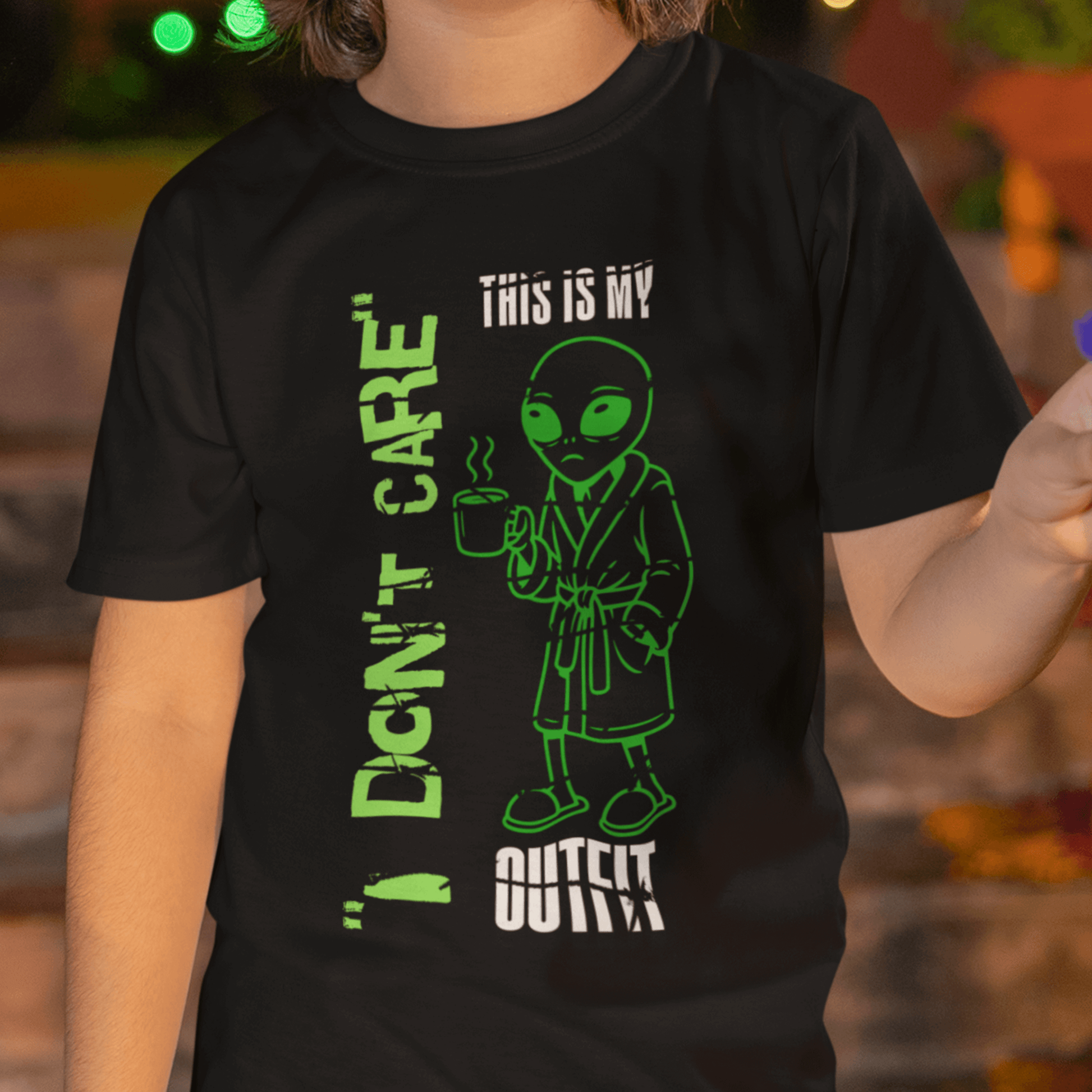 Child wearing youth graphic t-shirt with “I Don’t Care Alien” design, casual short sleeve tee by LostLogicCo Canada