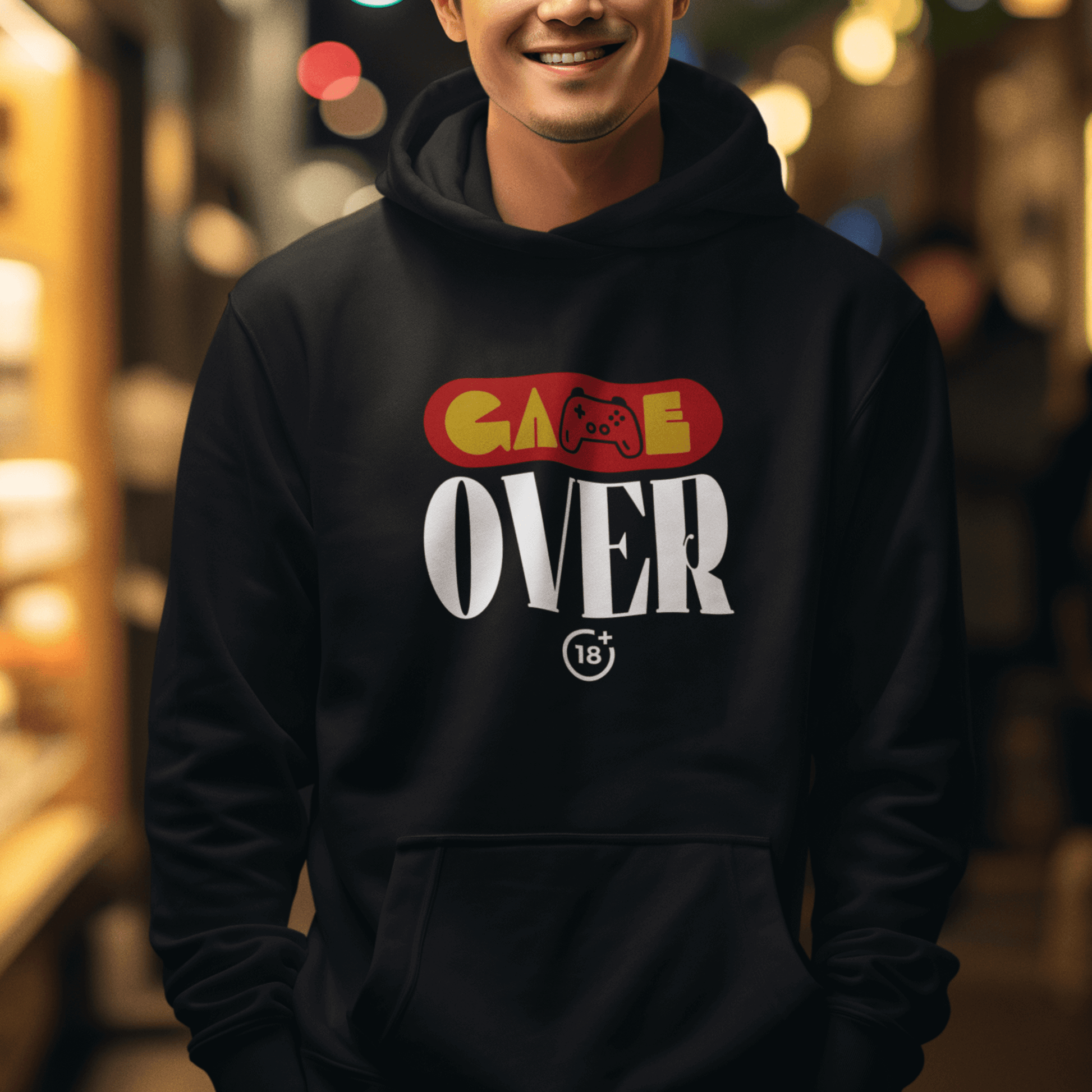 Model wearing black hoodie with retro “Game Over” controller-themed graphic, unisex gamer streetwear by LostLogicCo Canada
