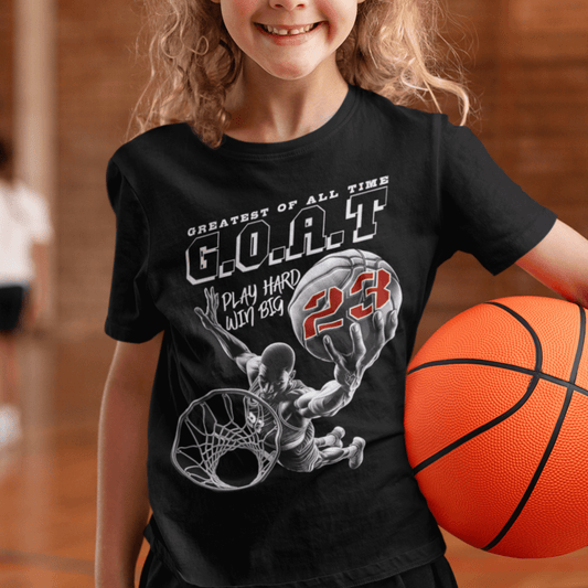 Child wearing youth basketball t-shirt with “G.O.A.T Slam Dunk 23” graphic design, casual short sleeve sports tee by LostLogicCo Canada