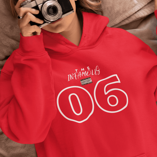 Female Model wearing red hoodie featuring white outlined “06” and stylish upper-text graphic, minimal streetwear by LostLogicCo Canada