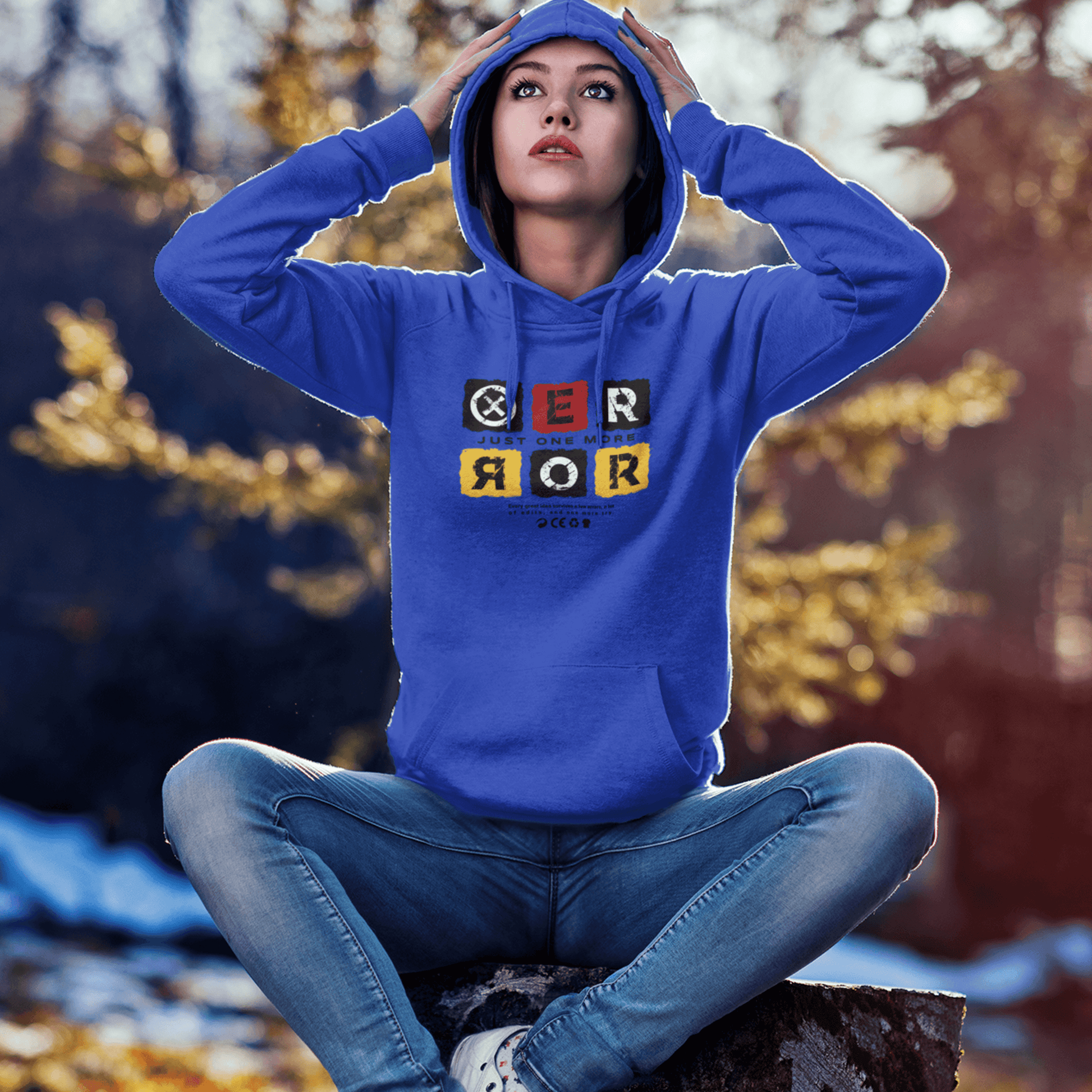 Model wearing Just One More Error hoodie with bold typography design in casual setting