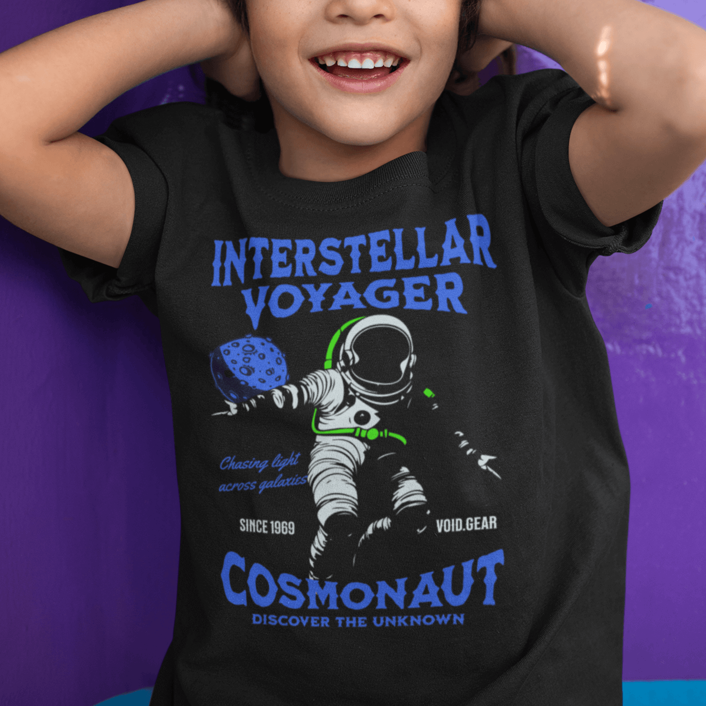 Child wearing youth graphic t-shirt with “Interstellar Voyager Cosmonaut” astronaut design, casual cotton-poly tee by LostLogicCo Canada