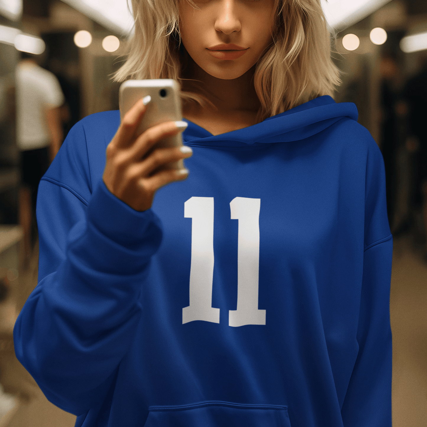 Female Model wearing blue hoodie with white “11” number design, minimal sporty streetwear by LostLogicCo Canada