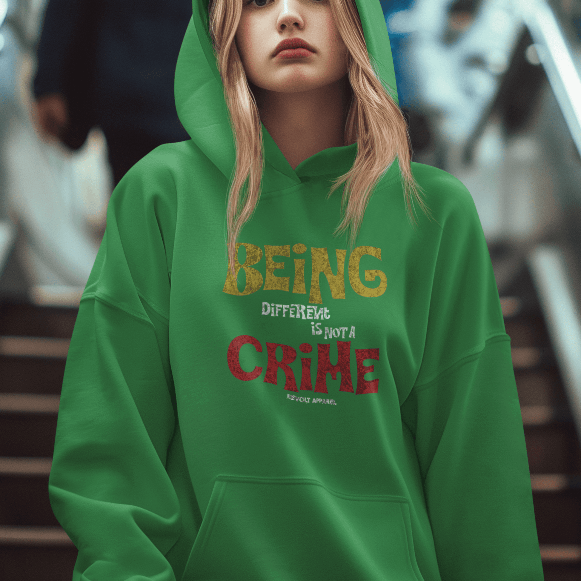 Female Model wearing green hoodie featuring bold statement graphic “Being Different Is Not a Crime,” unisex motivational streetwear by LostLogicCo Canada