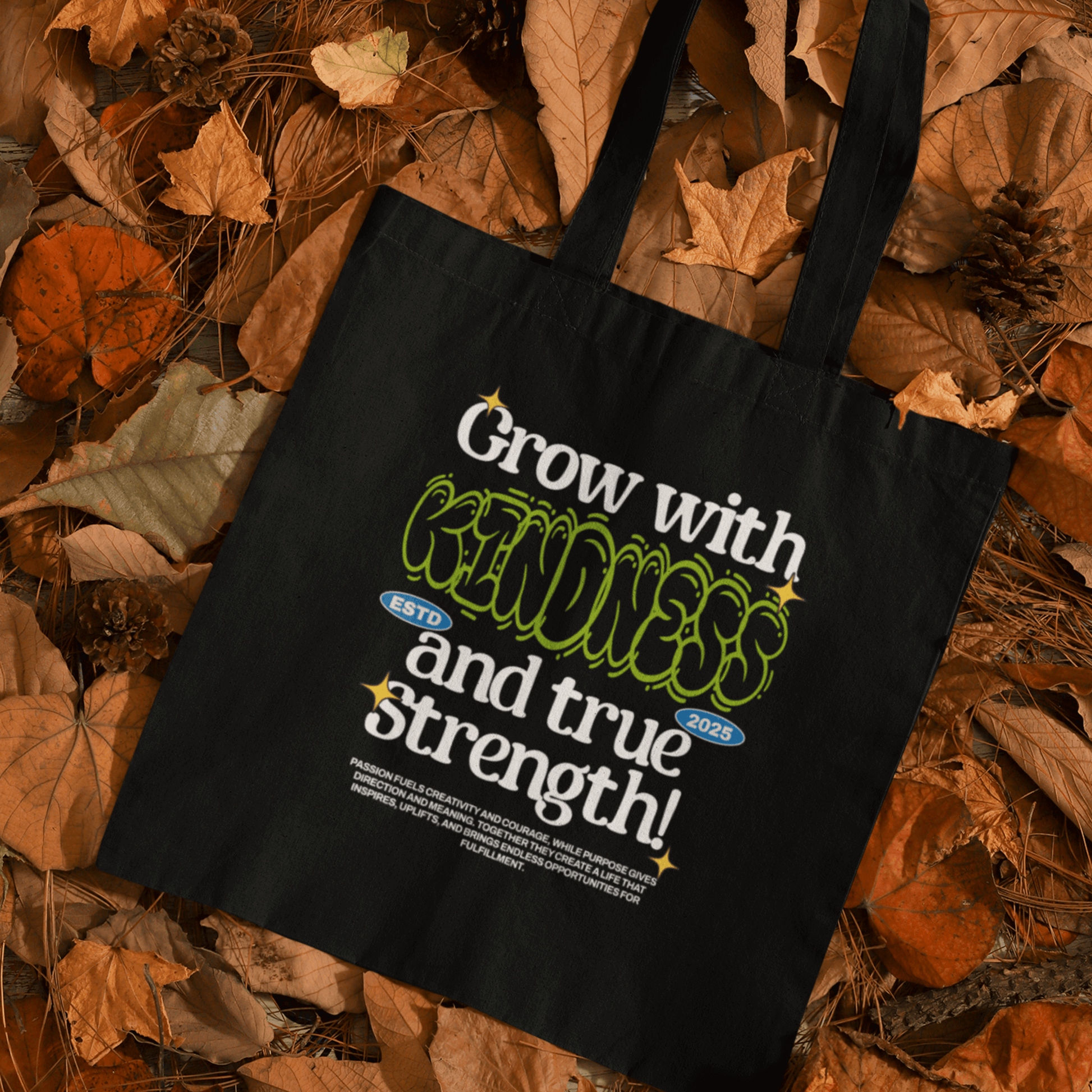 Eco tote bag with “Grow with Kindness and True Strength” motivational typography design in white, green, and blue on black organic cotton by LostLogicCo Canada.