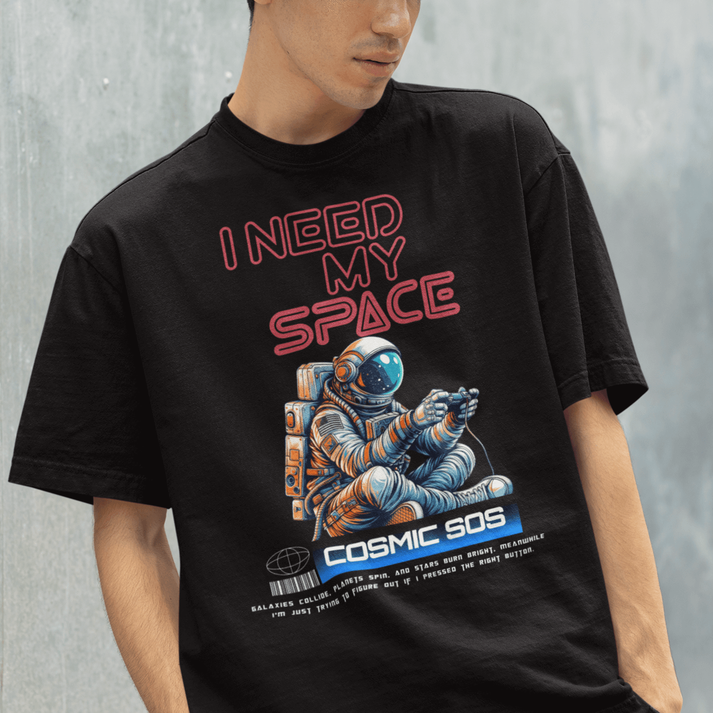 Model wearing “I Need My Space Cosmic SOS” astronaut design t-shirt, black unisex cotton tee by LostLogicCo Canada