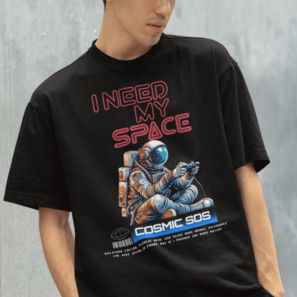 Model wearing “I Need My Space Cosmic SOS” astronaut design t-shirt, black unisex cotton tee by LostLogicCo Canada