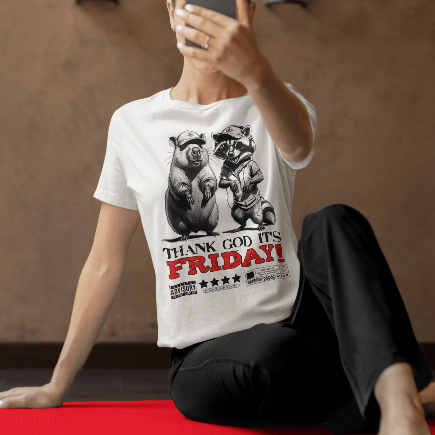 Model wearing unisex graphic t-shirt with “Thank God It’s Friday!” cartoon animal design, casual softstyle tee by LostLogicCo Canada
