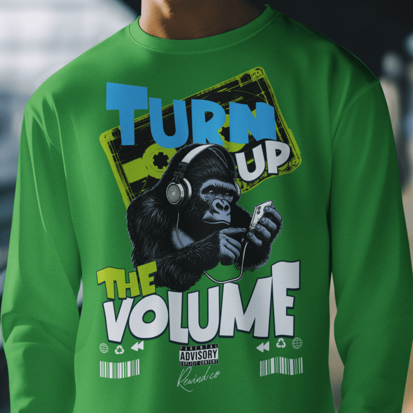 Model wearing unisex music graphic sweatshirt with “Turn Up the Volume” gorilla design, casual crewneck by LostLogicCo Canada