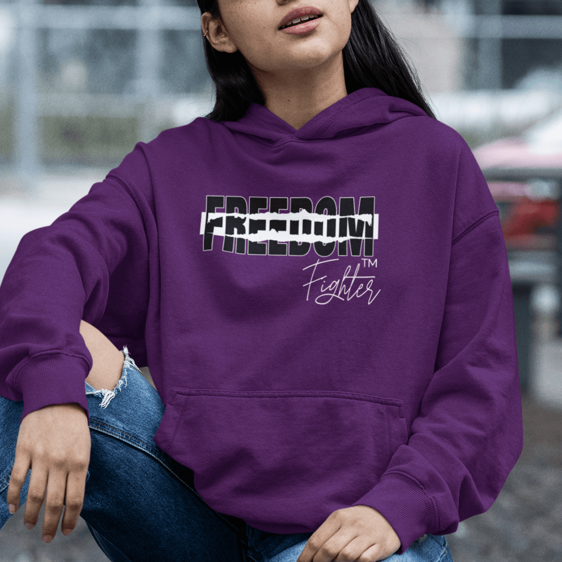 Female Model wearing purple hoodie featuring torn “FREEDOM” text and script “Fighter,” motivational streetwear by LostLogicCo Canada