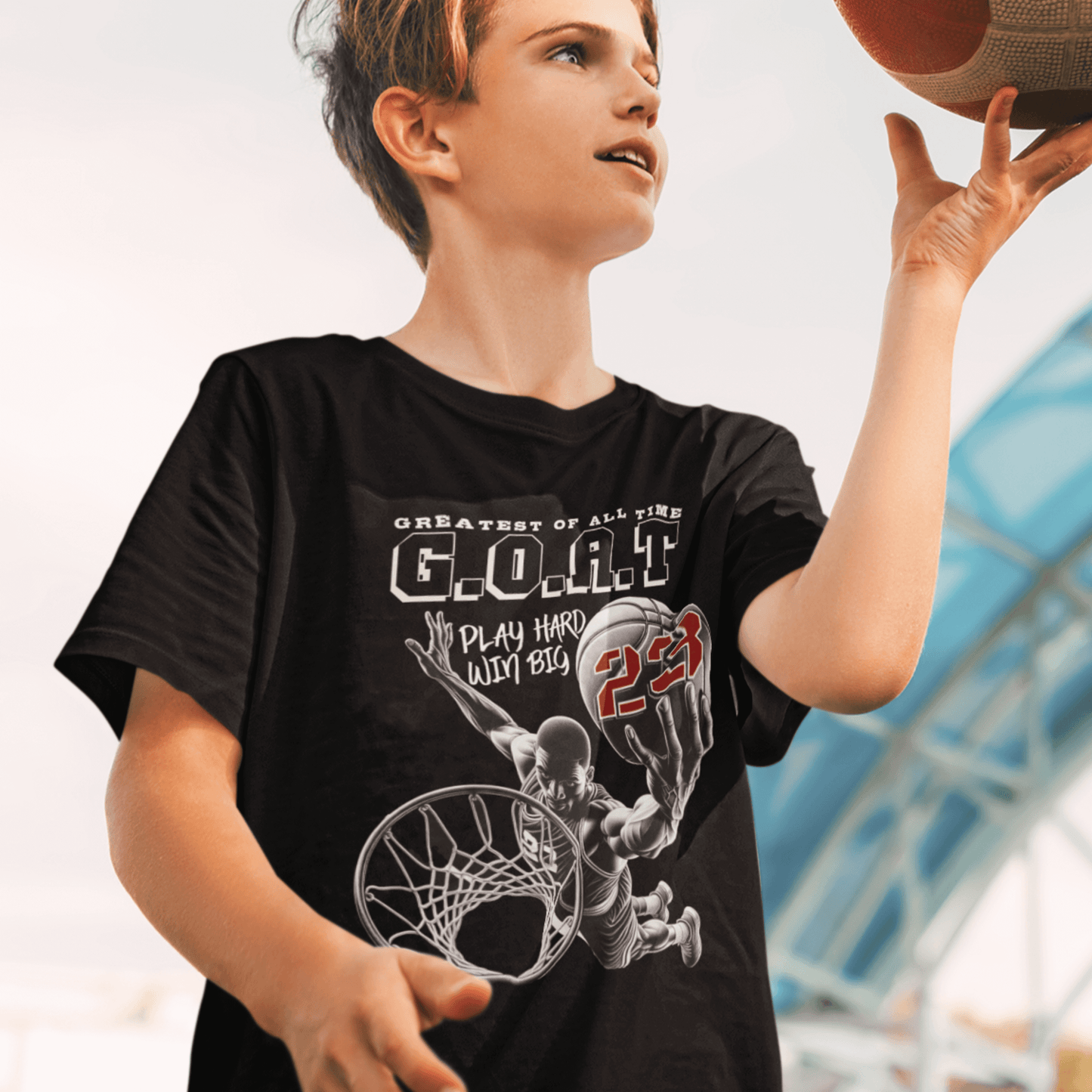 Child wearing youth basketball t-shirt with “G.O.A.T Slam Dunk 23” graphic design, casual short sleeve sports tee by LostLogicCo Canada