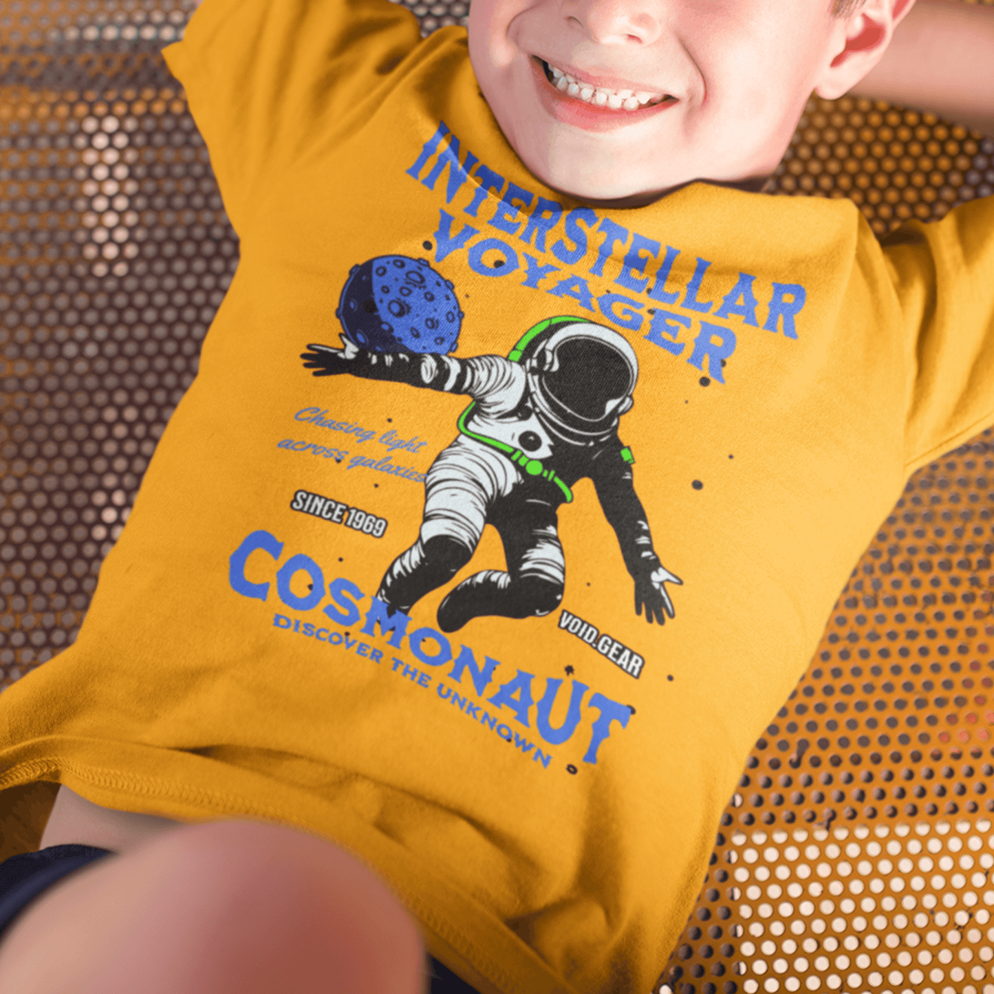 Child wearing youth graphic t-shirt with “Interstellar Voyager Cosmonaut” astronaut design, casual cotton-poly tee by LostLogicCo Canada