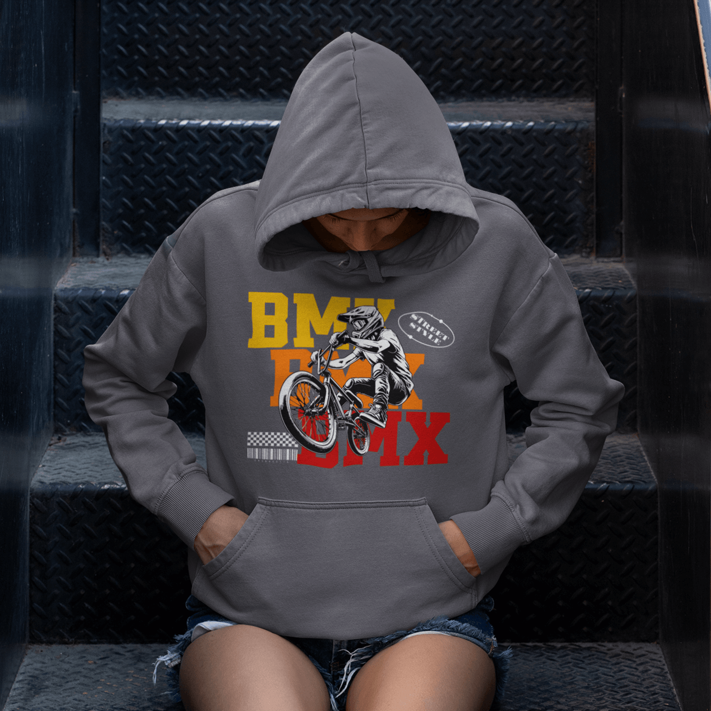 Female Model wearing BMX stunt graphic hoodie featuring bold colors and dynamic bike action, unisex streetwear by LostLogicCo Canada
