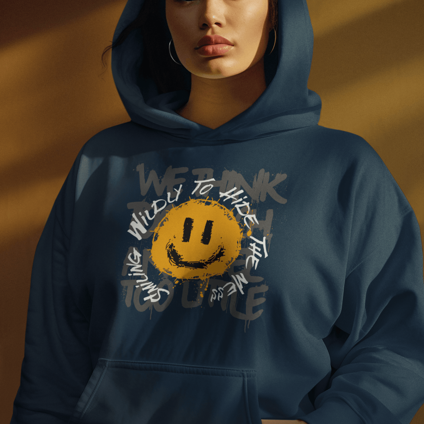 Female Model wearing navy blue hoodie featuring grunge smiley graphic and layered text, expressive streetwear style by LostLogicCo Canada