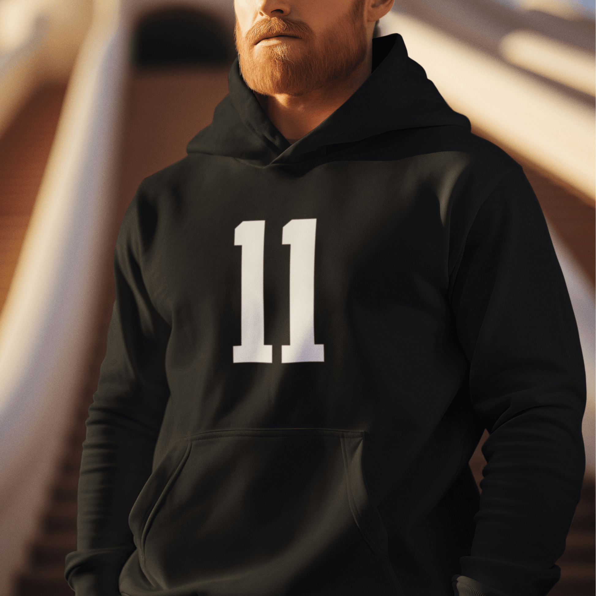 Model wearing black hoodie with white “11” number design, minimal sporty streetwear by LostLogicCo Canada