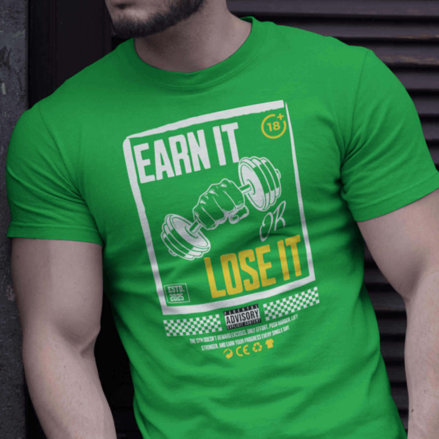 Model wearing “Earn It or Lose It” gym motivation t-shirt with bold dumbbell artwork and yellow text, unisex cotton tee by LostLogicCo Canada