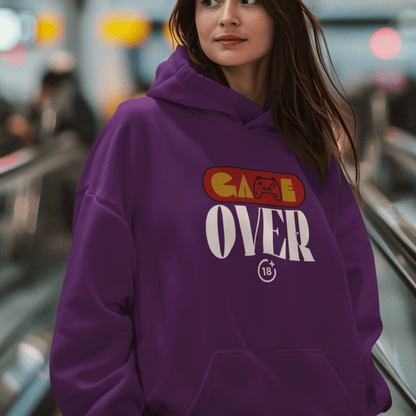 Female Model wearing purple hoodie with retro “Game Over” controller-themed graphic, unisex gamer streetwear by LostLogicCo Canada