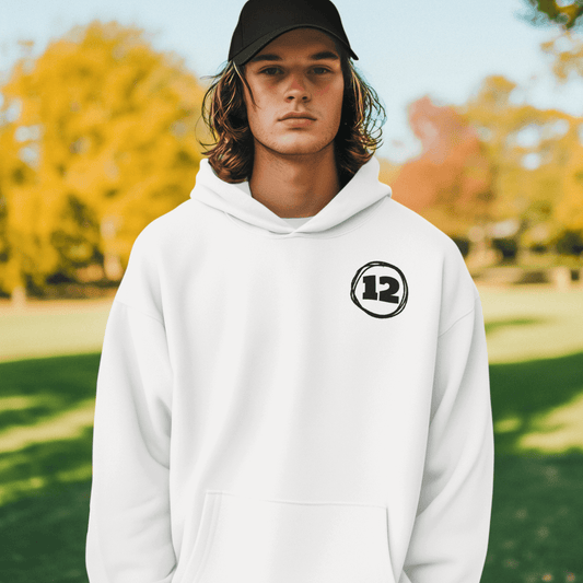 Model wearing white hoodie featuring minimal black “12” circle emblem on chest, clean unisex streetwear by LostLogicCo Canada