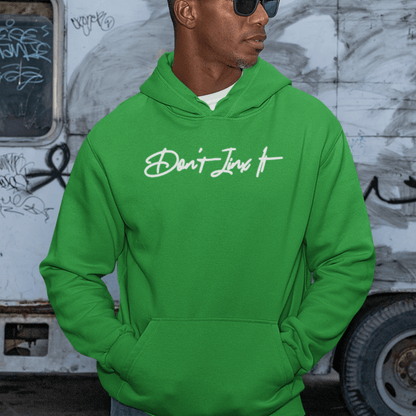 Male Model wearing green hoodie featuring white handwritten “Don’t Jinx It” script, modern minimal streetwear by LostLogicCo Canada
