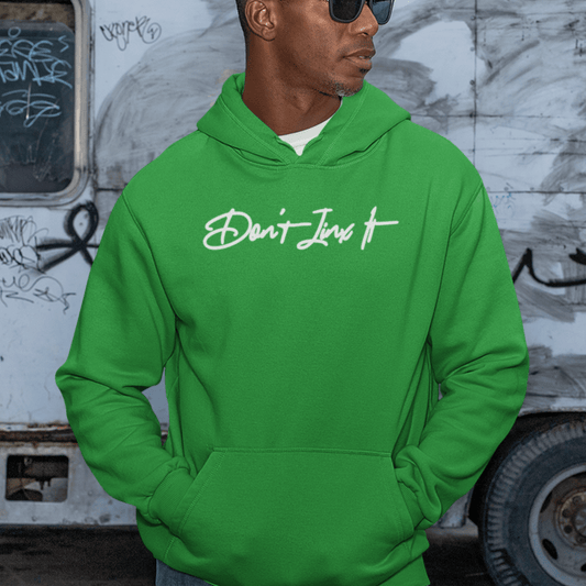 Male Model wearing green hoodie featuring white handwritten “Don’t Jinx It” script, modern minimal streetwear by LostLogicCo Canada