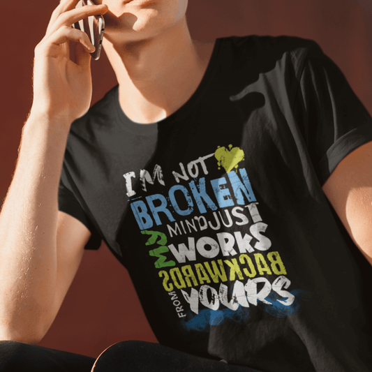 Model wearing unisex typography t-shirt with “I’m Not Broken My Mind Works Backwards From Yours” design, casual softstyle cotton tee by LostLogicCo Canada