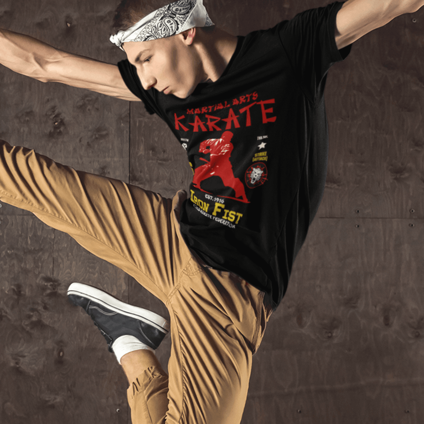 Model wearing unisex martial arts t-shirt with “Iron Fist Karate” design, casual softstyle cotton tee by LostLogicCo Canada