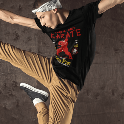 Model wearing unisex martial arts t-shirt with “Iron Fist Karate” design, casual softstyle cotton tee by LostLogicCo Canada