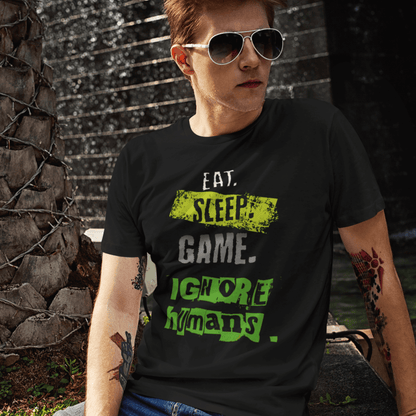 Model wearing unisex gamer typography t-shirt with “Eat Sleep Game Ignore Humans” design, casual short sleeve tee by LostLogicCo Canada